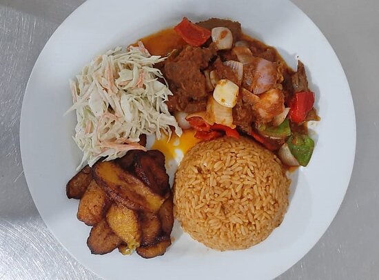 Jollof Rice, salad, plantain, and Goatmeat